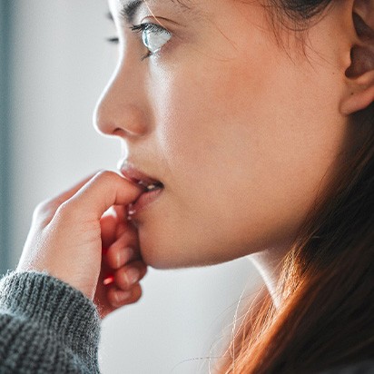 Closeup of woman biting her nails