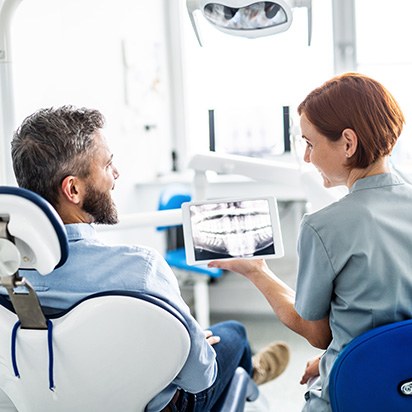 Patient and dentist looking at X-ray