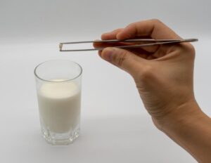 Person putting their knocked-out tooth in milk